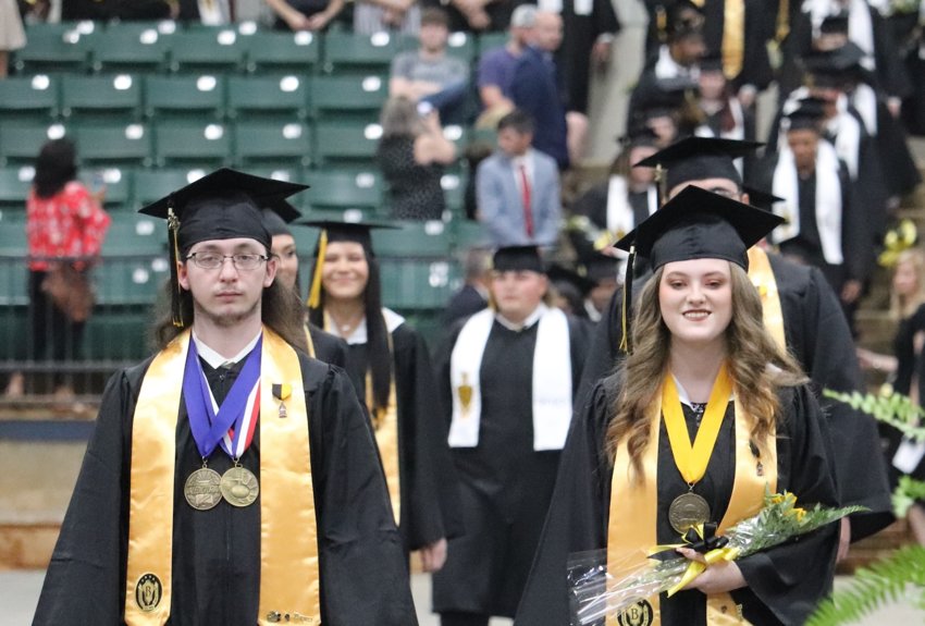 Union High School Valedictorian Greg Palculict, left, and Salutatorian Autumn Payne, right, lead the student procession on May 13 at the Neshoba County Coliseum.
